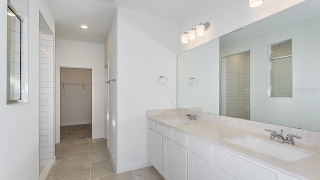 bathroom with vanity, tile patterned flooring, and walk in shower