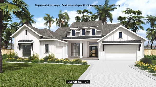 modern farmhouse featuring a garage and a front yard