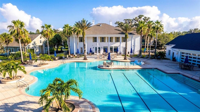 view of swimming pool with a patio