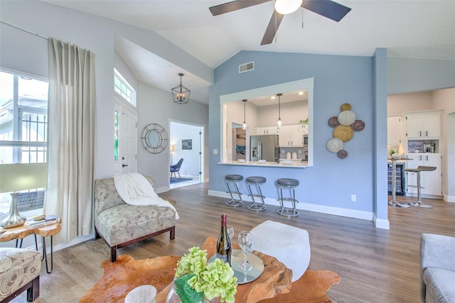 living room with ceiling fan, high vaulted ceiling, and wood-type flooring