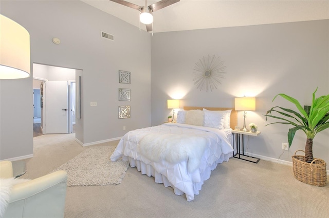 carpeted bedroom featuring a towering ceiling