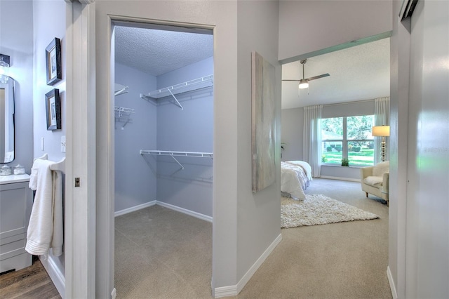 bathroom featuring ceiling fan and a textured ceiling