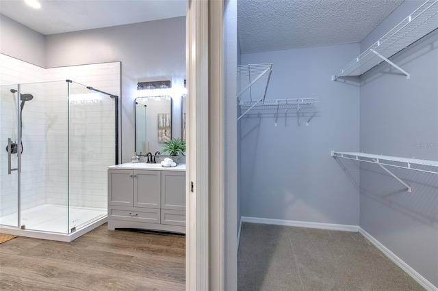 walk in closet featuring hardwood / wood-style flooring and sink