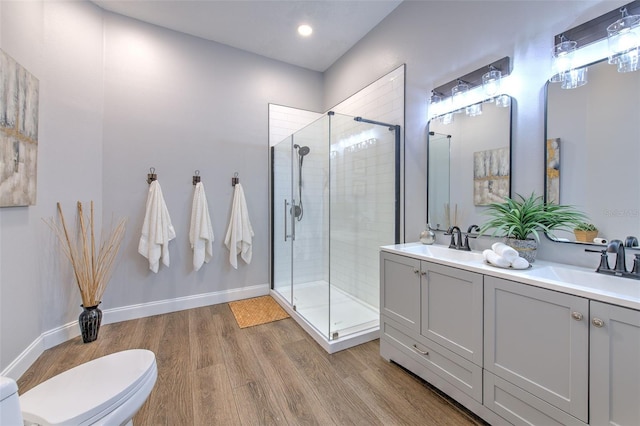 bathroom featuring an enclosed shower, vanity, toilet, and hardwood / wood-style floors