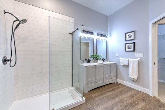 bathroom featuring vanity, hardwood / wood-style floors, and tiled shower