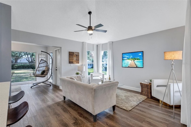 2309 Mooney Pl, Sun City Center, FL 33573 - living room with ceiling fan, a textured ceiling, vaulted ceiling, wood finished floors, and baseboards
