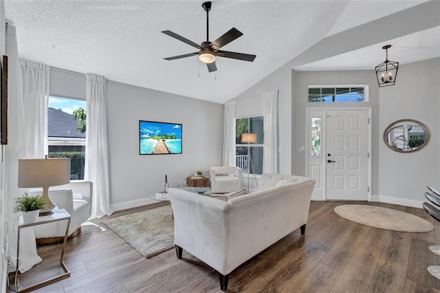 2309 Mooney Pl, Sun City Center, FL 33573 - living room featuring wood finished floors, vaulted ceiling, and a healthy amount of sunlight