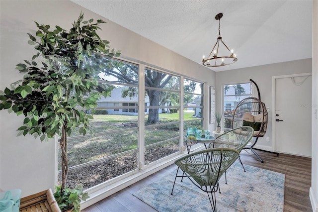 2309 Mooney Pl, Sun City Center, FL 33573 - dining area with an inviting chandelier, wood finished floors, and vaulted ceiling