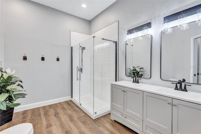 2309 Mooney Pl, Sun City Center, FL 33573 - bathroom featuring toilet, a shower stall, a sink, and wood finished floors