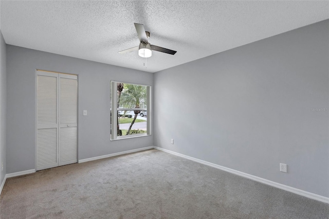 2309 Mooney Pl, Sun City Center, FL 33573 - unfurnished bedroom featuring a closet, a ceiling fan, baseboards, a textured ceiling, and carpet flooring