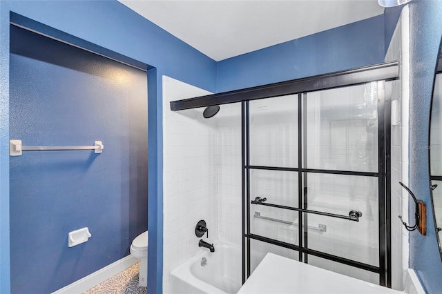 2309 Mooney Pl, Sun City Center, FL 33573 - bathroom with toilet, baseboards, and  shower combination