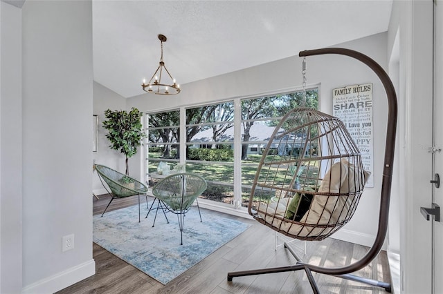 2309 Mooney Pl, Sun City Center, FL 33573 - dining room featuring an inviting chandelier, baseboards, wood finished floors, and a wealth of natural light