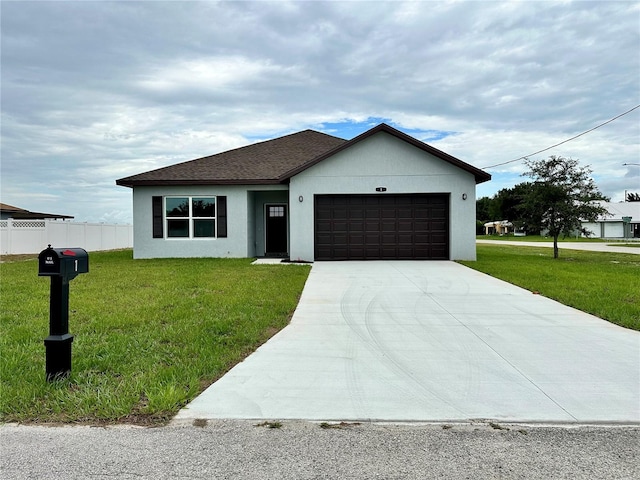 view of front of property featuring a front yard and a garage