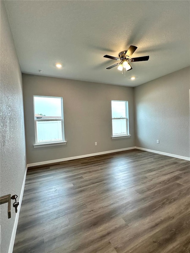 empty room featuring ceiling fan and hardwood / wood-style flooring