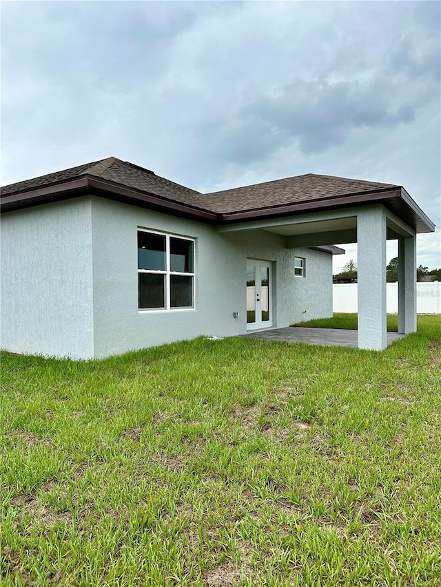 back of property featuring a patio, french doors, and a lawn