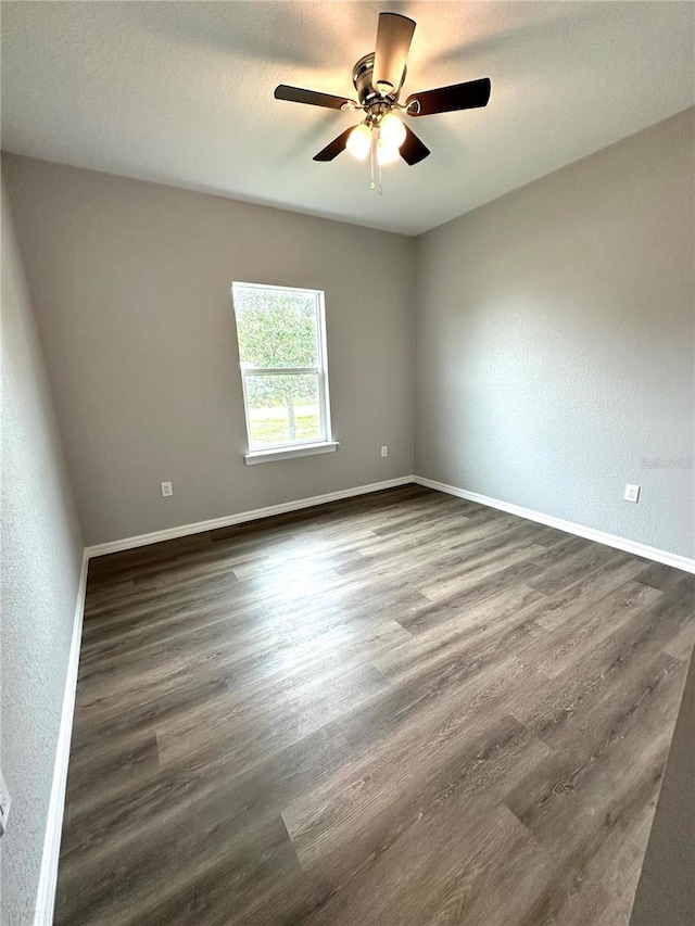 unfurnished room with ceiling fan and wood-type flooring