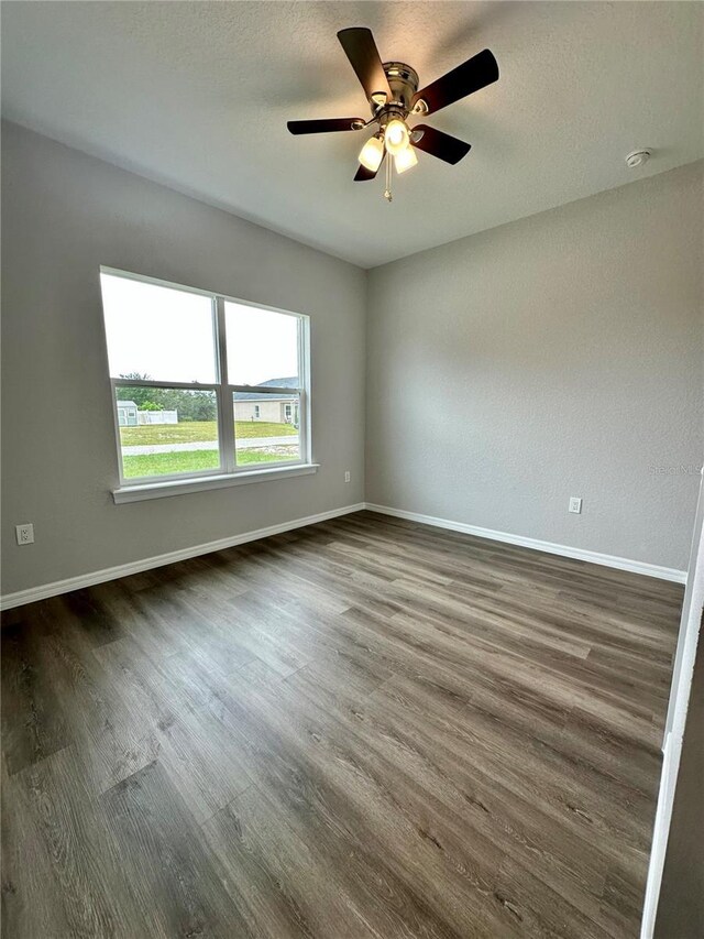 unfurnished room with ceiling fan and hardwood / wood-style flooring