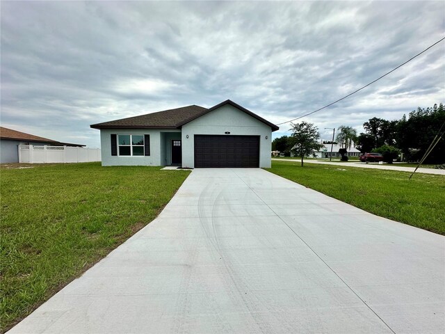 view of front of house with a front lawn and a garage