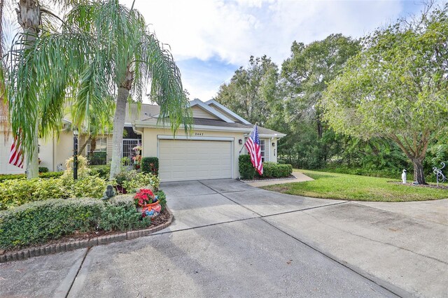 view of front of house featuring a garage and a front lawn