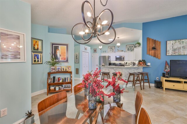 dining space with a notable chandelier and a textured ceiling