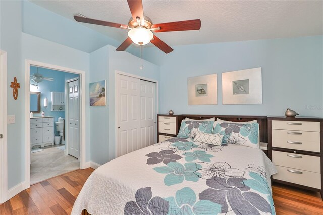 bedroom with ceiling fan, a closet, vaulted ceiling, hardwood / wood-style flooring, and ensuite bathroom