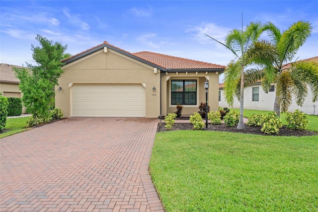 mediterranean / spanish-style home featuring a front yard and a garage