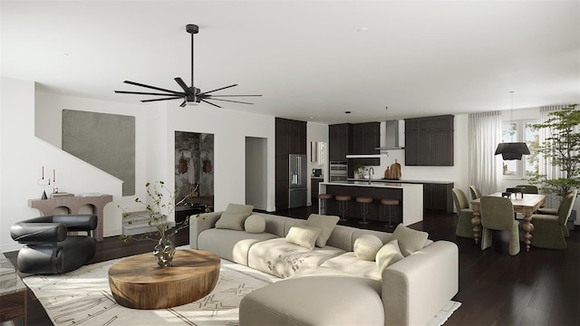 living room featuring dark hardwood / wood-style floors, sink, and ceiling fan