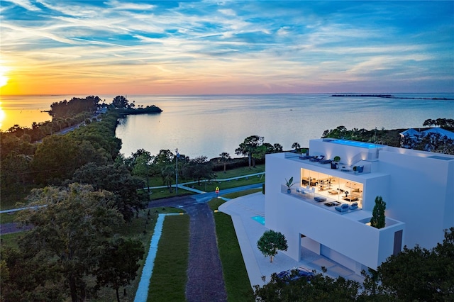 aerial view at dusk with a water view