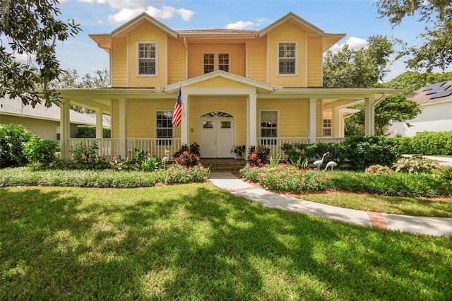 view of front of property featuring covered porch and a front lawn