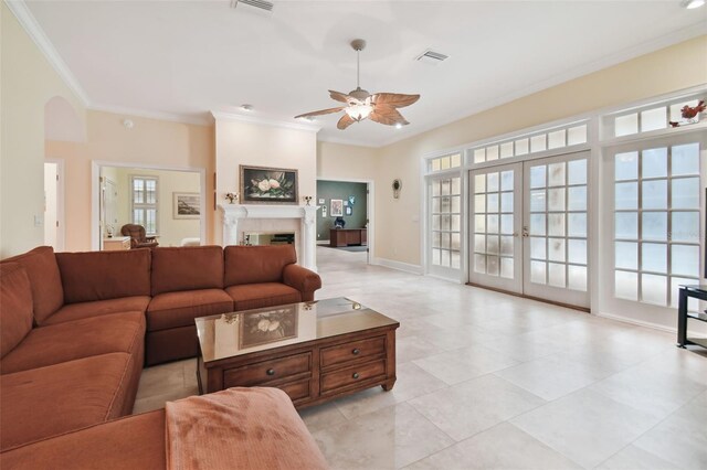 living room featuring ceiling fan, crown molding, light tile patterned flooring, and french doors