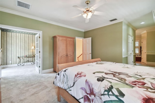 bedroom with visible vents, ornamental molding, and light colored carpet