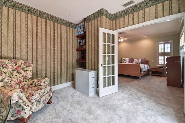 living area with light carpet, wallpapered walls, visible vents, and french doors