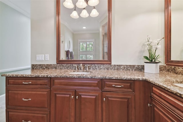 bathroom with crown molding and vanity