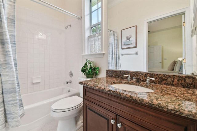 full bathroom with tile patterned flooring, shower / bath combination with curtain, toilet, and vanity