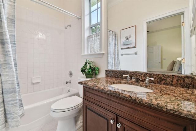 bathroom featuring toilet, shower / bath combo, and vanity