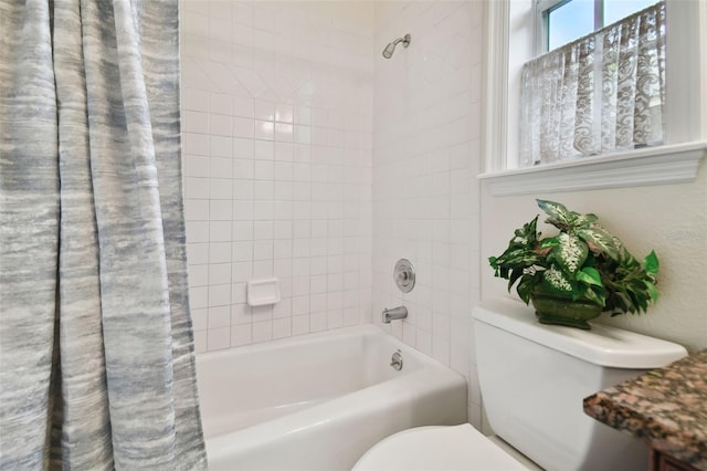 bathroom with shower / bathtub combination with curtain and toilet