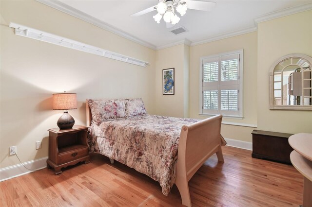 bedroom featuring ceiling fan, crown molding, and wood-type flooring