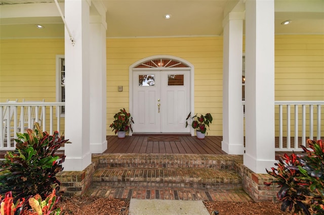 view of exterior entry featuring a porch