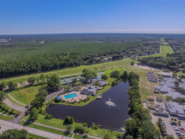 birds eye view of property with a water view and a view of trees