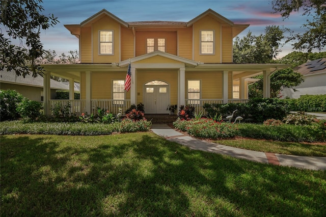 view of front of property with a porch and a front yard