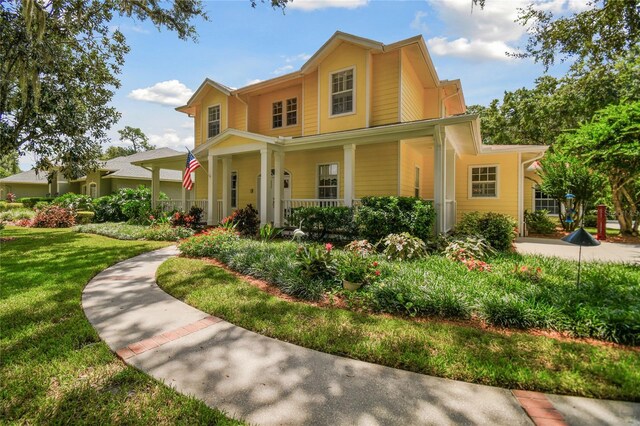 view of front of house with a front lawn and a porch