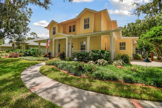 view of front facade featuring covered porch and a front yard