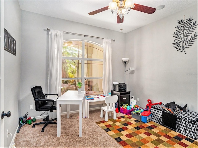 carpeted office space with ceiling fan