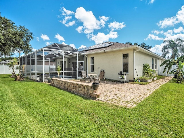 back of house with a yard, a lanai, a patio, and a swimming pool