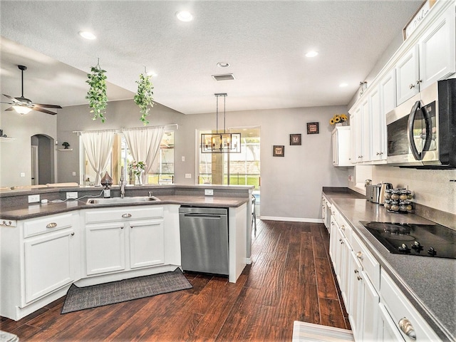 kitchen featuring appliances with stainless steel finishes, dark hardwood / wood-style floors, white cabinetry, and sink