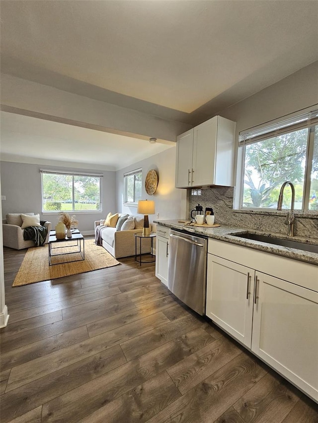 3763 Dartmouth Ave N, Saint Petersburg, FL 33713 - kitchen featuring stainless steel dishwasher, a sink, open floor plan, light stone counters, and dark wood finished floors