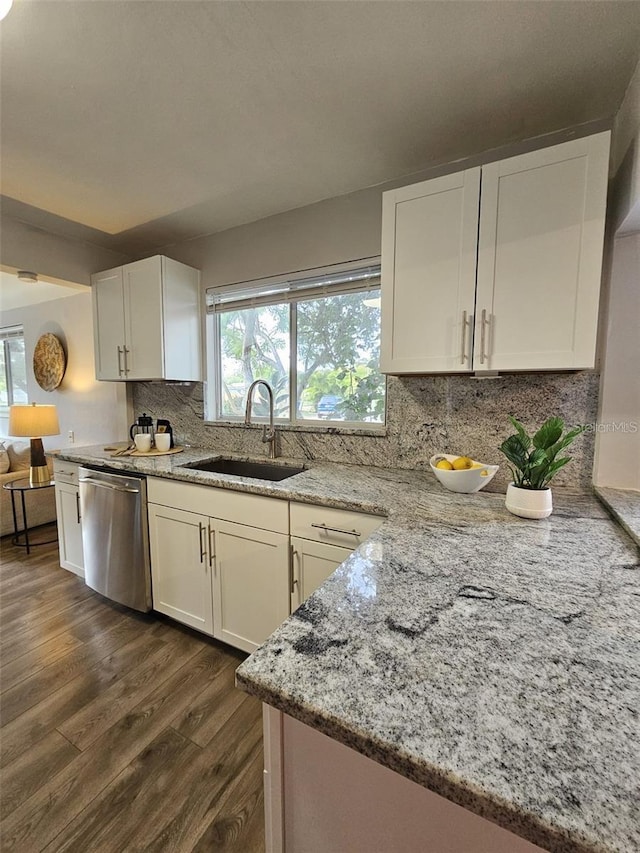 3763 Dartmouth Ave N, Saint Petersburg, FL 33713 - kitchen with a sink, stainless steel dishwasher, dark wood finished floors, light stone countertops, and white cabinetry