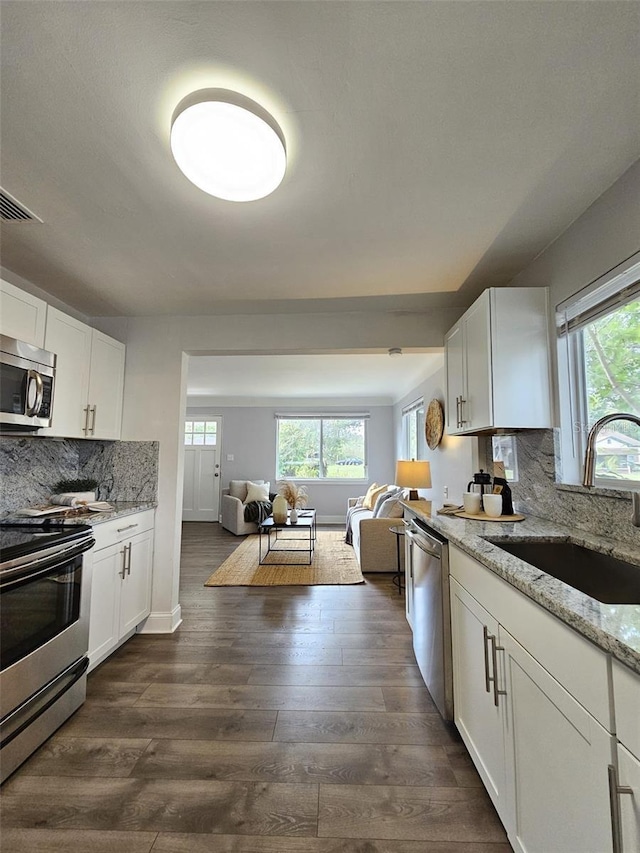3763 Dartmouth Ave N, Saint Petersburg, FL 33713 - kitchen featuring appliances with stainless steel finishes, a sink, open floor plan, and healthy amount of natural light