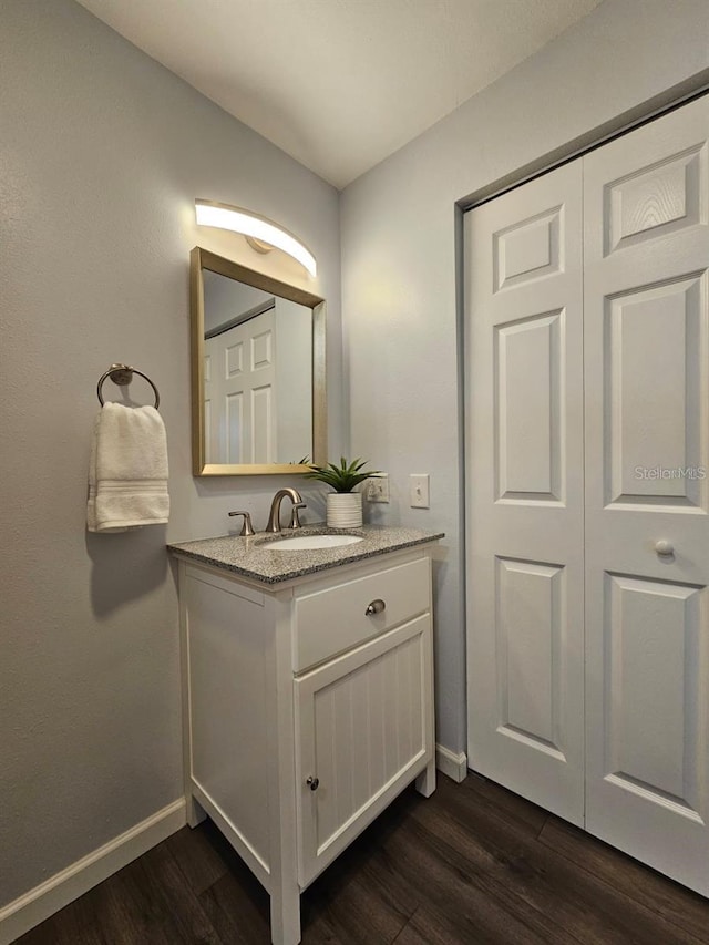 3763 Dartmouth Ave N, Saint Petersburg, FL 33713 - bathroom featuring wood finished floors, baseboards, and vanity