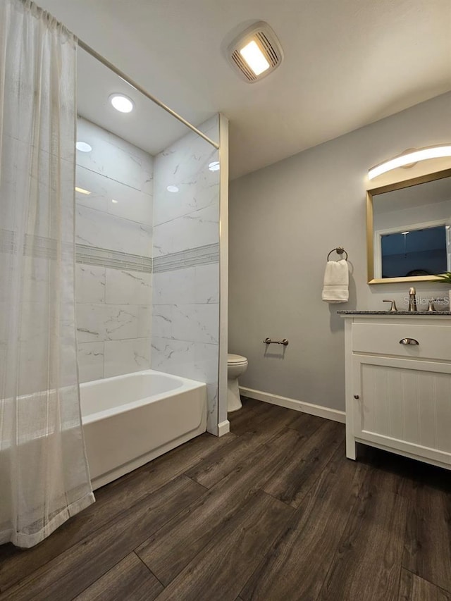 3763 Dartmouth Ave N, Saint Petersburg, FL 33713 - bathroom with wood finished floors, toilet, shower / bath combination with curtain, vanity, and baseboards